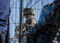 [1/3]A Texas law enforcement officer stands guard at the border as migrants cross from Mexico into El Paso, Texas, U.S., March 22, 2024. REUTERS/Justin Hamel/File Photo Purchase Licensing Rights