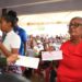 A resident from Region Nine with her cheque yesterday. (Office of the Prime Minister photo)
