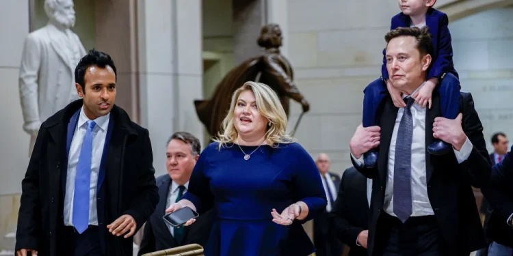 Elon Musk carries his son on his shoulders at the U.S. Capitol following a meeting with businessman Vivek Ramaswamy Dec. 5. The two Trump advisers have come under fire from MAGA loyalists over their positions on H-1B visas.Anna Moneymaker / Getty Images