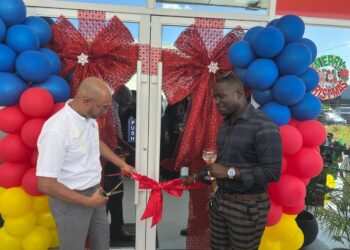 The ceremonial ribbon cutting. Left is Garfield Manasseh, Sales Manager Trade with Vinroy Johnson of Str8edge Superior Painting