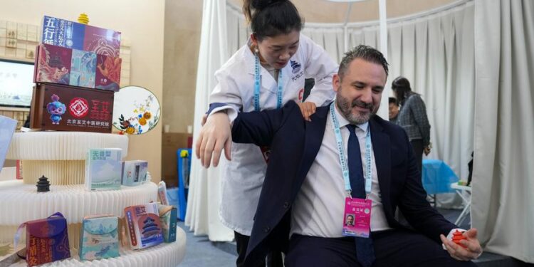 BEIJING, Dec. 3, 2024 (Xinhua) -- A British delegate experiences a Chinese traditional therapy during the 2024 World Conference on Traditional Medicine in Beijing, capital of China, Dec. 3, 2024. The conference kicked off Tuesday in Beijing under the theme "Diversity, Inheritance and Innovation: Traditional Medicine for All." (Xinhua/Ju Huanzong)
