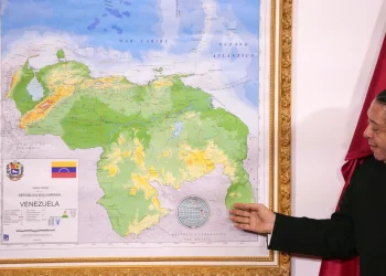 Chairman of the Special Commission for the Defense of Guyana Essequibo Hermann Escarra, stands next to Venezuela’s new map that includes the Essequibo territory, a swath of land that is administered and controlled by Guyana but claimed by Venezuela, during an unveiling ceremony in Caracas, Venezuela, Dec. 8, 2023. (AP Photo/Matias Delacroix, File)