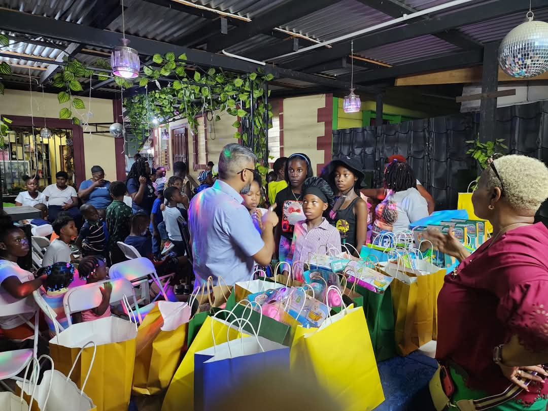 Fr City mayor Pt. Ubraj Narine and Voda Lawrence distributing gifts on December 23, 2024