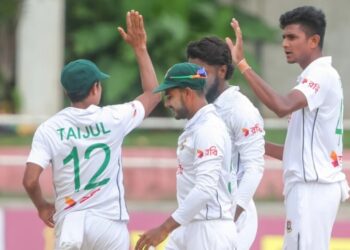 Nahid Rana (right) celebrating a wicket with his teammates.