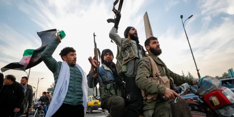 Syrian opposition fighters celebrate in Damascus [Omar Sanadiki/AP Photo]