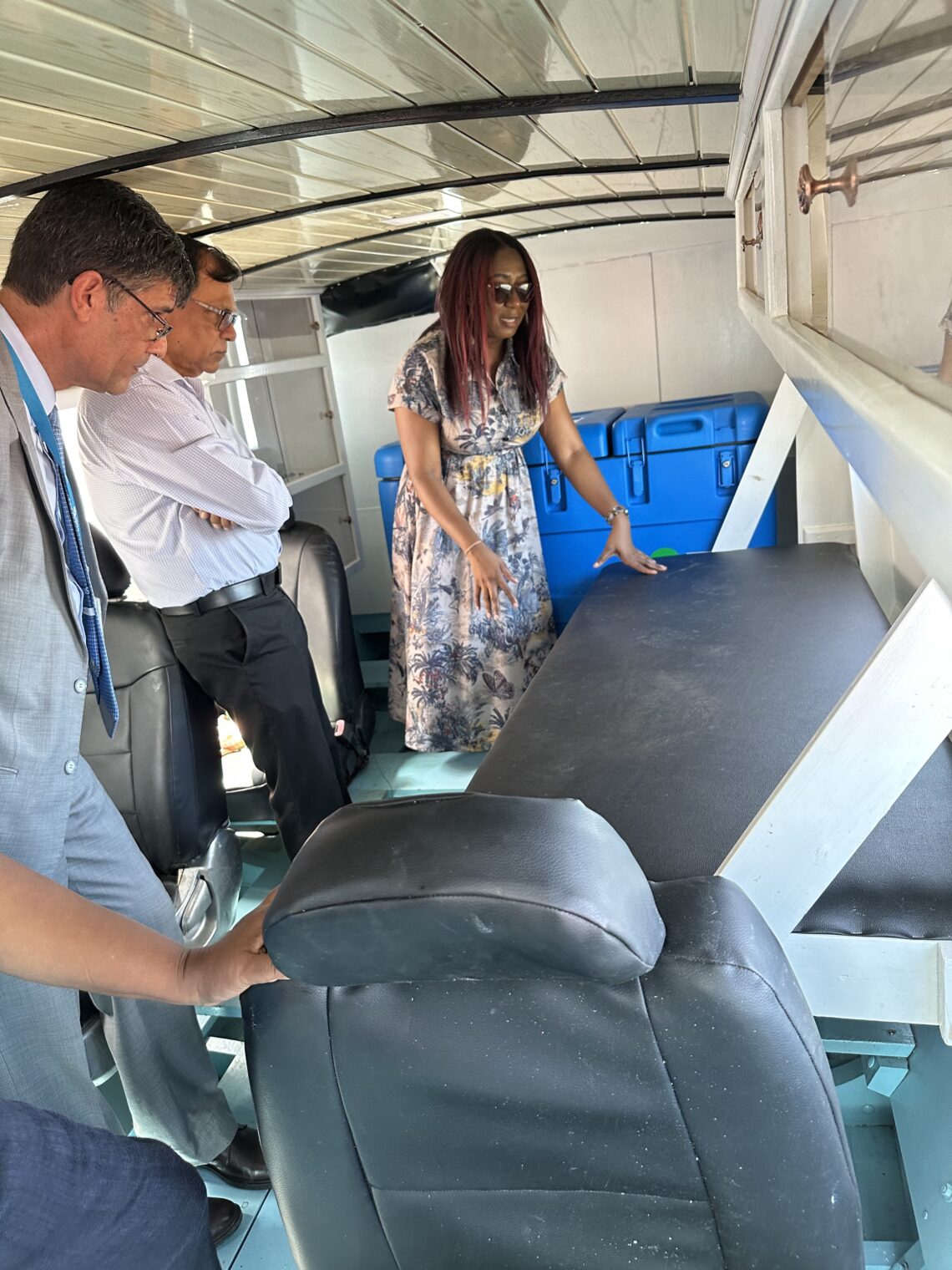 Dr. Oneka Scott, Maternal and Child Health Officer showcasing the retractable bed on the specially designed vaccine boats
