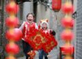 Children holding lanterns and Chinese knots have fun at a community in Yangzhou City, east China's Jiangsu Province, Jan. 24, 2025. (Photo by Meng Delong/Xinhua)