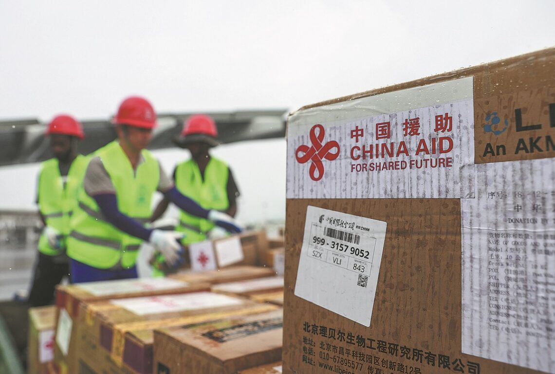 Workers transport China-aided emergency relief supplies in Port Vila on Thursday. LONG LEI/XINHUA