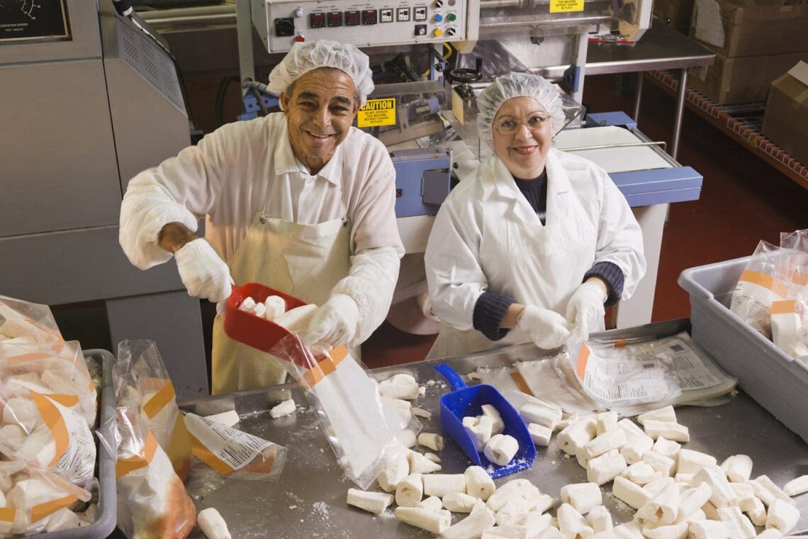 Workers package frozen cassava in bags at a Florida food processing plant. Juan Silva/The Image Bank via Getty Images