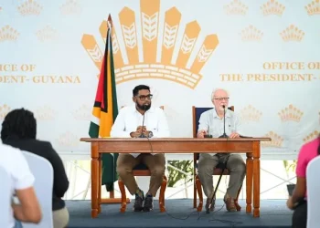 President Irfaan Ali alongside his Public Communications Consultant, Kit Nascimento at the press conference (DPI photo)
