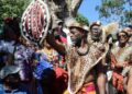 Accompong Maroon Chief Richard Currie holds aloft the gift he got from His Royal Highness Papa ATEKER Paul Jones Eganda, president of AIDO International/Uganda Global Afraka,