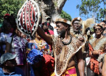 Accompong Maroon Chief Richard Currie holds aloft the gift he got from His Royal Highness Papa ATEKER Paul Jones Eganda, president of AIDO International/Uganda Global Afraka,