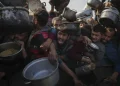 Palestinians struggle for food at a distribution center in Khan Younis, Gaza Strip, Jan. 9, 2025. (AP Photo/Abdel Kareem Hana, File)