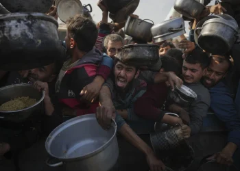 Palestinians struggle for food at a distribution center in Khan Younis, Gaza Strip, Jan. 9, 2025. (AP Photo/Abdel Kareem Hana, File)