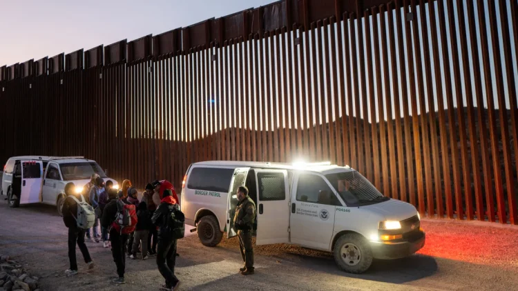 Migrants turn themselves in to US Customs and Border Patrol officers after crossing over a section of border wall into the US on January 5, 2025 in Ruby, Arizona. Brandon Bell/Getty Images