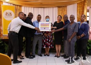 From R-L: Dr Diana Gobin, Deputy Vice-Chancellor, Finance; Dr Nigel Gravesande, Registrar, UG; Dr Emanuel Cummings, Deputy Vice-Chancellor, Academic Engagement; Vice-Chancellor, Professor Paloma Mohamed Martin; Hon. Priya Manickchand, Minister of Education; Dr Mohandat Goolsarran, Chair of the National Accreditation Council (NAC); Dr Marcel Hutson, CEO of the National Accreditation Council; and Dr Jacqueline Maurry, Director of IDCE, receive the Accreditation certificate from the National Accreditation Council at a ceremony held at the Education Lecture Theatre (ELT) at UG’s Turkeyen Campus.