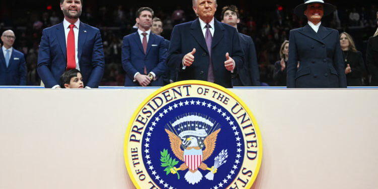 President Donald Trump next to Vice President J.D. Vance and First Lady Melania Trump, gives two thumb's up during the inaugural parade inside Capital One Arena, in Washington, D.C., Jan. 20, 2025.
Jim Watson/AFP via Getty Image