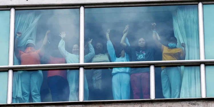 People holding hands on Feb. 18 at a hotel in Panama City where migrants from Asia and the Middle East were housed after being deported from the United States.Enea Lebrun / Reuters file