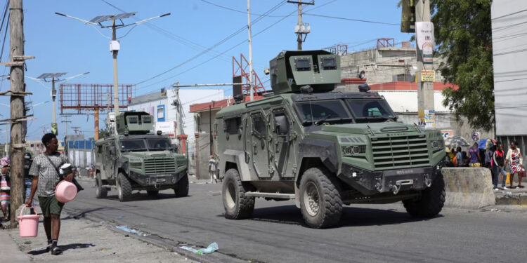 Armored vehicles of the Kenyan peace-keeping mission patrol as residents flee their neighborhood due to gang violence, in Port-au-Prince, Haiti, Feb. 25, 2025.