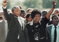 Nelson and Winnie Mandela walk together in this iconic photo after he's released from prison in 1990