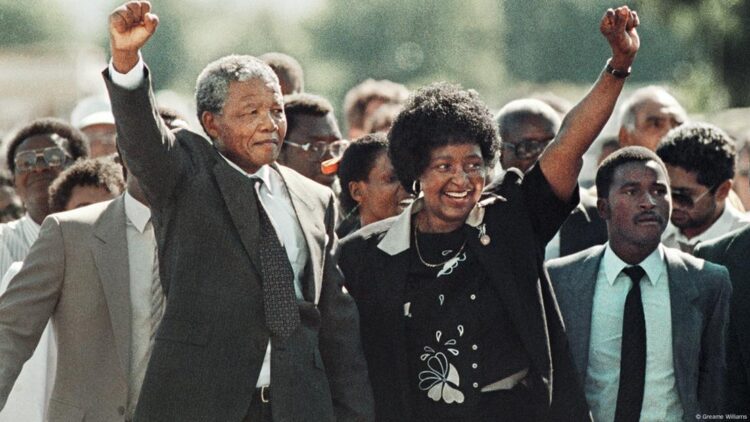 Nelson and Winnie Mandela walk together in this iconic photo after he's released from prison in 1990