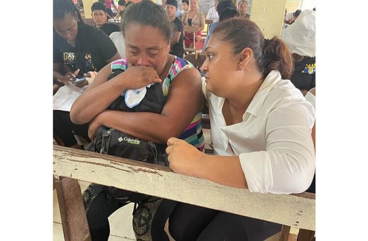 Minister of Education Priya Manickchand with Valerie Carter, mother of 15-year-old twins Mary and Martha D’Andrade, who are among those who perished in the May 21, 2023 tragedy (Ministry of Education photos)