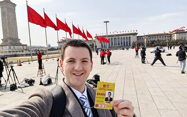 Dylan Walker takes a selfie in front of the Great Hall of the People on March 4.
