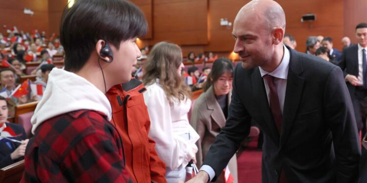 French Minister for Europe and Foreign Affairs Jean-Noel Barrot greets a student at Beijing Language and Culture University on Thursday. Barrot began a two-day visit to China on Thursday. Zou Hong / CHINA DAILY