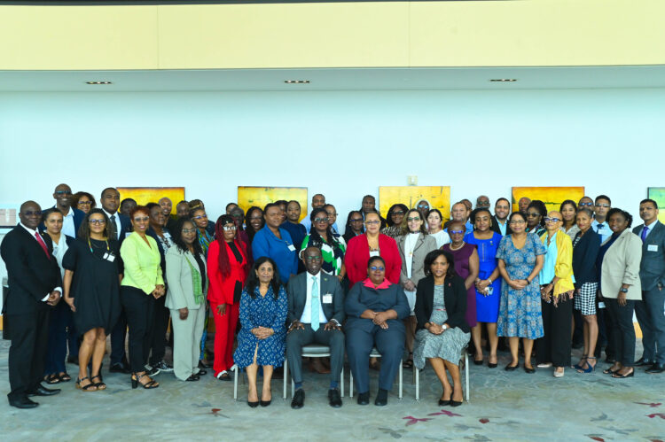 Group Photograph of the participants of the Ninth Meeting of National AIDS Program Managers and Key Partners. Seated L-R, Dr. Shanti Singh Anthony, Coordinator, Knowledge Management, PCU, Dr. Armstrong Alexis, Deputy Secretary-General, CARICOM Secretariat, Dr. Dale Babb, Senior Medical Officer of Health, responsible for HIV/AIDS, Barbados, Dr. Wendy Telgt Emanuelson, Director PCU