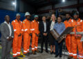 Several technicians pose with Dr. Singh, Ambassador Theriot and Director Persaud.