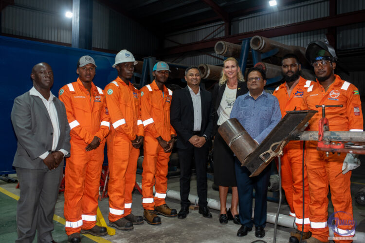Several technicians pose with Dr. Singh, Ambassador Theriot and Director Persaud.