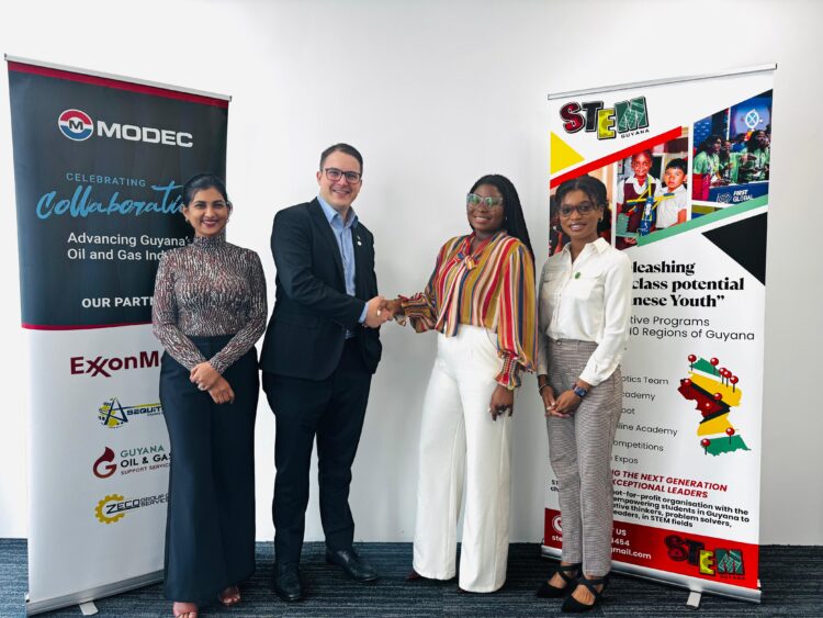 (Middle L-R) Rafael Fumis, Country Manager, MODEC Guyana and Elsie Harry, Board Member and Fundraising Coordinator, STEMGuyana; greet each other. They are flanked by Yolander Sammy, Legal & Compliance Manager, MODEC Guyana on the left, and Alisha Koulen, Operations Manager, STEMGuyana on the right.