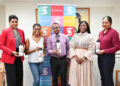 (L-R): Nafeeza Gaffoor, Country Manager, Scotiabank Guyana; Alisha Koulen, Operations Manager, STEMGuyana; Justin Thompson, Senior Manager, Country Management Office, Scotiabank Guyana; Elsie Harry, Board Member and Fundraising Coordinator, STEMGuyana and Bibi Alli, Senior Manager. Operations and Administration, Scotiabank Guyana display STEM branded tokens.