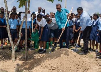 Foreign Secretary and Chairman of the Protected Areas Commission Board of Directors, Mr. Robert Persaud turning the ceremonial sod along with students to launch the National Tree Planting Project