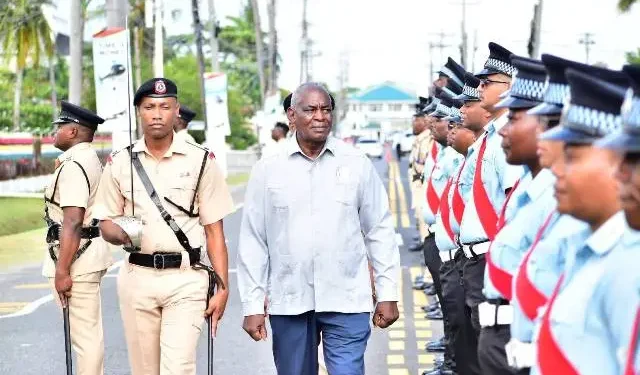 Minister of Home Affairs Robeson Benn inspects police officers during the opening of the conference (DPI photo)