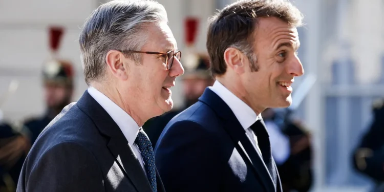 France's President Emmanuel Macron welcomes Britain's Prime Minister Keir Starmer as he arrives for a summit of the "Coalition of the Willing" in Paris on March 27. Ludovic Marin/AFP/Getty Images