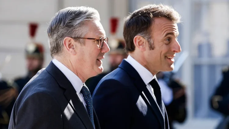 France's President Emmanuel Macron welcomes Britain's Prime Minister Keir Starmer as he arrives for a summit of the "Coalition of the Willing" in Paris on March 27. Ludovic Marin/AFP/Getty Images