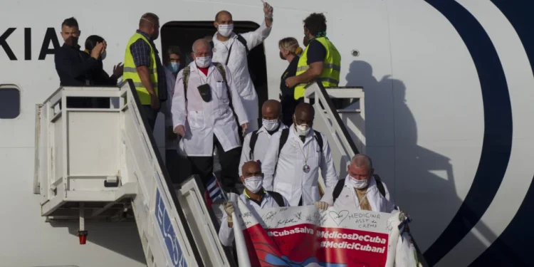 Cuban doctors arrive at the Jose Marti International Airport in Havana, Cuba, June 8, 2020, after traveling to Italy to help with the COVID-19 emergency response. (Ismael Francisco/Pool via AP, File)