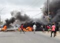 March 6, 2020- PPP/C supporters blocking the main access road at Bush Lot, lit fire on the streets, injured school children and policemen and set afire school buses