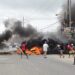 March 6, 2020- PPP/C supporters blocking the main access road at Bush Lot, lit fire on the streets, injured school children and policemen and set afire school buses