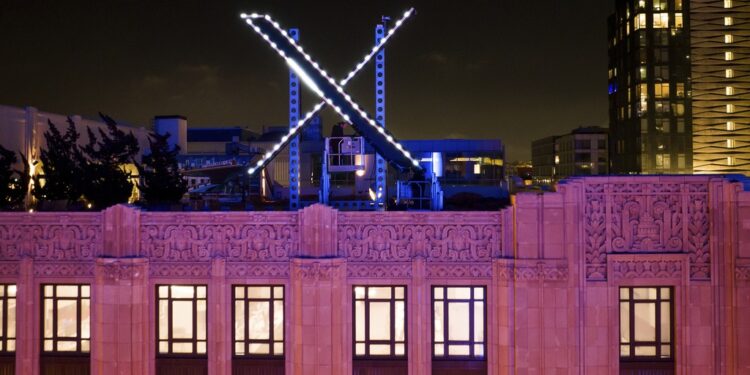 FILE - Workers install lighting on an "X" sign atop the company headquarters, formerly known as Twitter, in downtown San Francisco, on Friday, July 28, 2023. (AP Photo/Noah Berger, File)