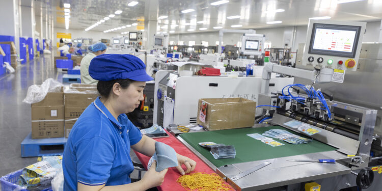 Workers on a line at Dino New Materials Technology Co., Ltd. in the Sihong Economic Development Zone, Suqian, Jiangsu Province, on April 16, 2025. /VCG