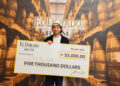 First Place Winner of the El Dorado Rum Heritage Cocktail Competition 2025, Erick Lerch, with cheque.