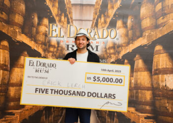 First Place Winner of the El Dorado Rum Heritage Cocktail Competition 2025, Erick Lerch, with cheque.