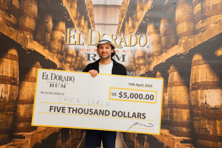 First Place Winner of the El Dorado Rum Heritage Cocktail Competition 2025, Erick Lerch, with cheque.
