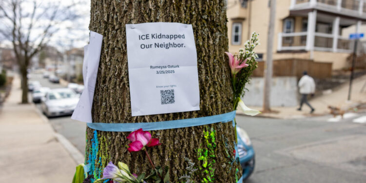 SOMERVILLE, MASSACHUSETTS - MARCH 27: Signage and flowers are placed on a tree next to where ICE agents apprehended Tuft University graduate student Rumeysa Ozturk on March 27, 2025 in Somerville, Massachusetts.  Ozturk was arrested for purported activities related to terrorist organizations amid the Trump administration's immigration crackdown.  (Photo by Scott Eisen/Getty Images)
