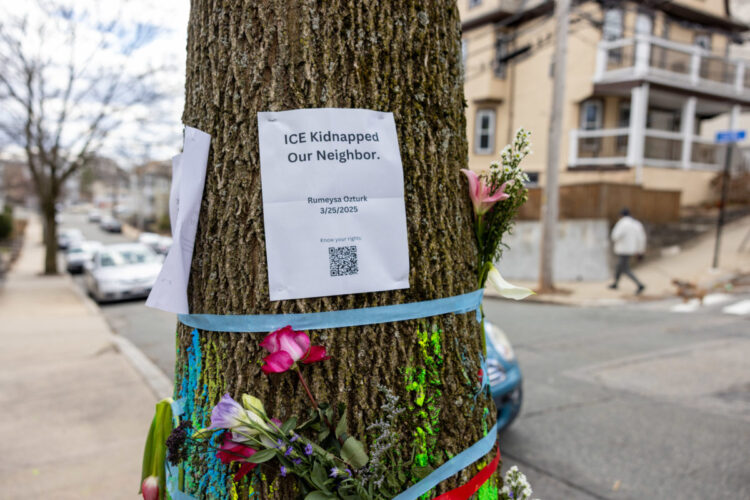 SOMERVILLE, MASSACHUSETTS - MARCH 27: Signage and flowers are placed on a tree next to where ICE agents apprehended Tuft University graduate student Rumeysa Ozturk on March 27, 2025 in Somerville, Massachusetts.  Ozturk was arrested for purported activities related to terrorist organizations amid the Trump administration's immigration crackdown.  (Photo by Scott Eisen/Getty Images)