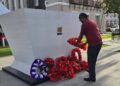 Vice Chairman of the Institute for Action Against Discrimination (IFAAD), Pt. Ubraj Narine, laying a wreath as Hubert Nathaniel Critchlow statue,