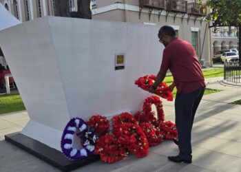 Vice Chairman of the Institute for Action Against Discrimination (IFAAD), Pt. Ubraj Narine, laying a wreath as Hubert Nathaniel Critchlow statue,