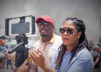Fmr Shadow Minister of Foreign Affairs and International Trade and FGM Presidential Candidate Amanza Walton-Desir (in blue shirt) engaging the press on the death of 11-year-old Arianna Younge